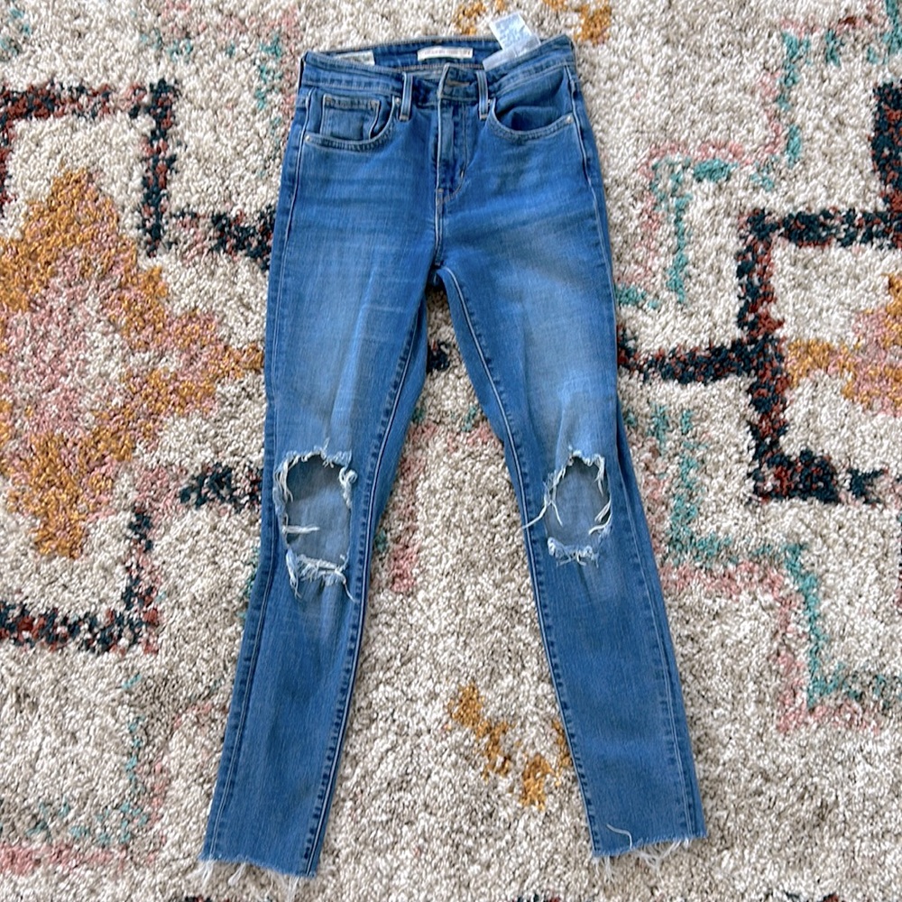 Levis premium denim high rise skinny. Knee holes and ankle fray. Size 24